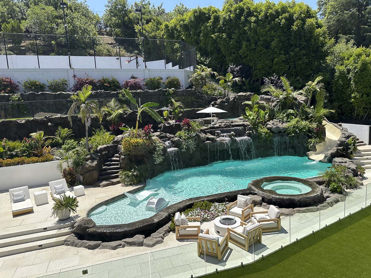 Naturalistic rockwork pool with waterfalls and lush landscaping